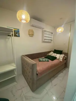 a bedroom with a brown couch in a room at Solne Apartamenty Luna 4 in Wieliczka