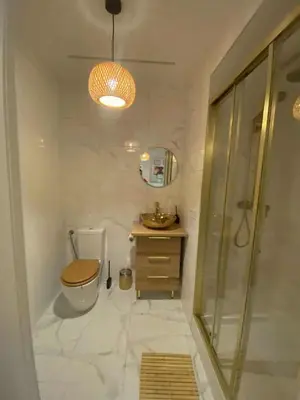 a bathroom with a toilet and a sink and a shower at Solne Apartamenty Luna 4 in Wieliczka