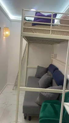 a room with two bunk beds and a couch at Solne Apartamenty Luna 4 in Wieliczka