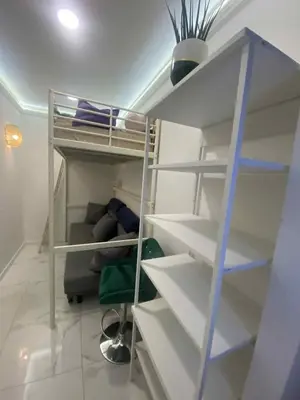 a room with a bunk bed and a couch at Solne Apartamenty Luna 4 in Wieliczka