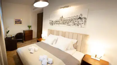 a bedroom with a bed with two towels on it at Apartments Roman in Kraków