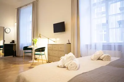 a bedroom with a bed with towels on it at Apartments Roman in Kraków