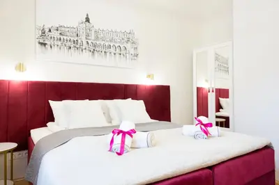 a bedroom with a large bed with bows on it at Apartments Roman in Kraków