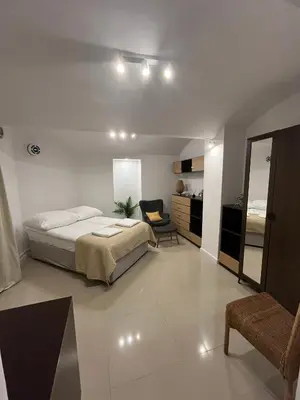 a bedroom with a bed and a chair in it at A&J Apartments in Kraków