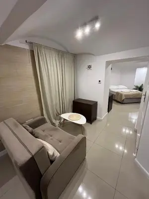 a living room with a couch and a bed at A&J Apartments in Kraków