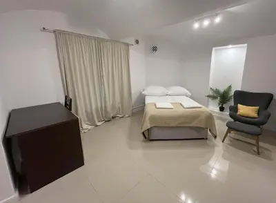 a bedroom with a bed and a chair in it at A&J Apartments in Kraków