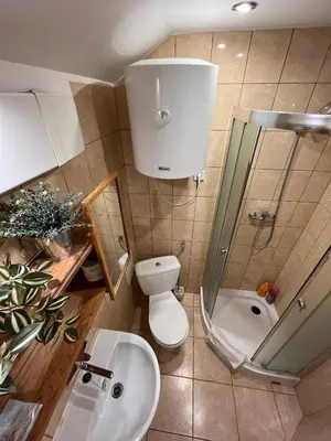 a small bathroom with a toilet and a sink at A&J Apartments in Kraków