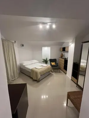a bedroom with a bed and a chair in it at A&J Apartments in Kraków