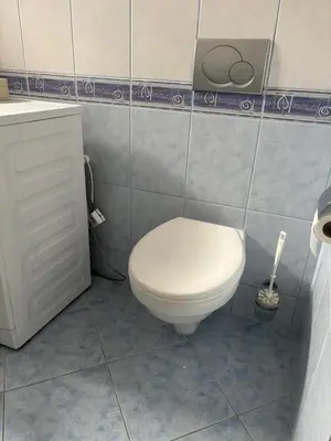 a bathroom with a white toilet and a sink at Rooms near Balice airport in Cholerzyn