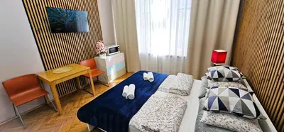 a small room with two beds and a desk at Old Town KRAKÓW STUDIO in Kraków