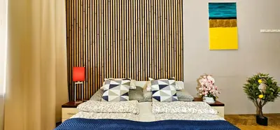 a bedroom with a bed with blue sheets and pillows at Old Town KRAKÓW STUDIO in Kraków
