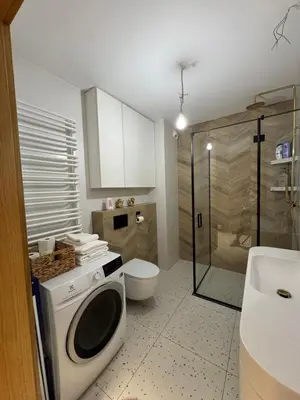 a bathroom with a washing machine and a toilet at Mieszkanie do wynajęcia Rydlówka Kraków in Kraków