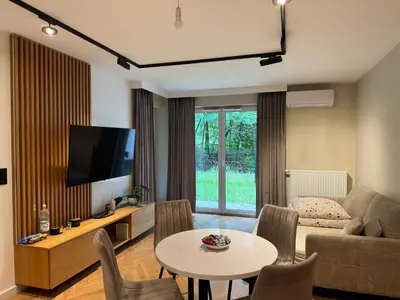 a living room with a couch and a table at Mieszkanie do wynajęcia Rydlówka Kraków in Kraków