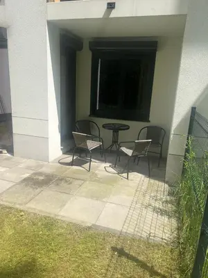 a patio with chairs and a table and a window at Mieszkanie do wynajęcia Rydlówka Kraków in Kraków