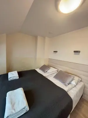 a bedroom with two beds with towels on them at Vintage Studencka 25 Apartment in Kraków