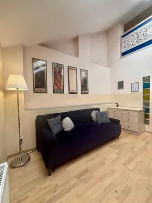 a living room with a blue couch in a room at Vintage Studencka 25 Apartment in Kraków