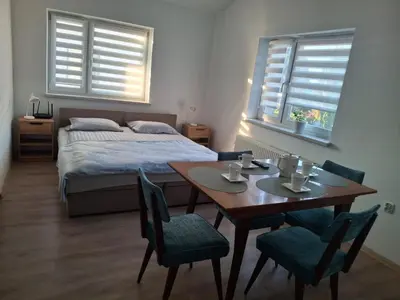 a bedroom with a bed and a table and chairs at Mieszkanie Paszkówka in Paszkówka