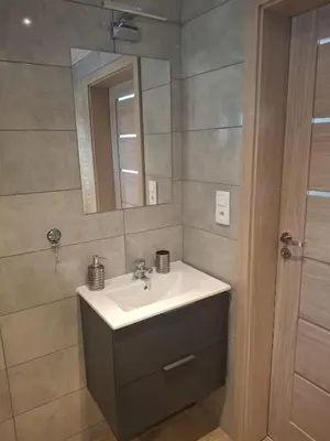 a bathroom with a sink and a mirror at Mieszkanie Paszkówka in Paszkówka