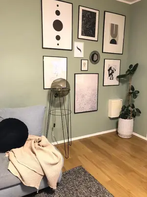 a living room with a couch and pictures on the wall at Komfortowy apartament blisko Tauron Areny in Kraków