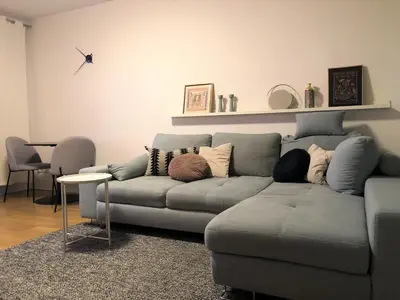 a living room with a couch with pillows on it at Komfortowy apartament blisko Tauron Areny in Kraków