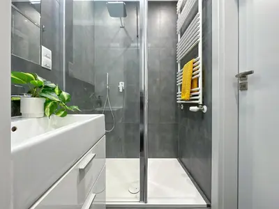 a bathroom with a shower and a sink at Apartament Śliwka w Krakowie in Kraków