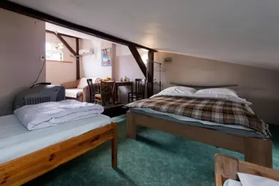 a bedroom with two beds and a dining room at Love Bridge Apartments in Kraków