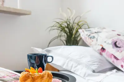 a table with a plate of food and a coffee cup at Jasmine's apartment in Kraków