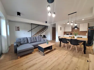 a living room with a couch and a table at Magic Apartments - Zatoria in Zator