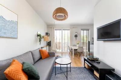 a living room with a couch and a tv at Przewóz Charming Nest Apartment by BookingHost in Kraków
