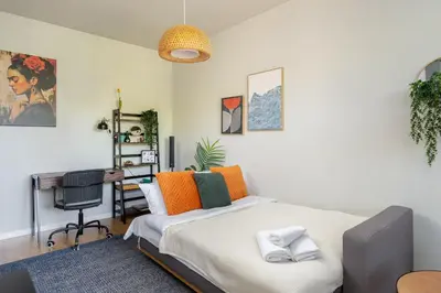 a bedroom with a bed and a desk at Przewóz Charming Nest Apartment by BookingHost in Kraków
