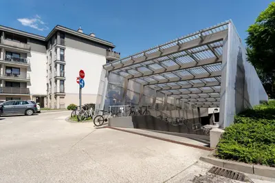 a building with bikes parked in a parking lot at Przewóz Charming Nest Apartment by BookingHost in Kraków