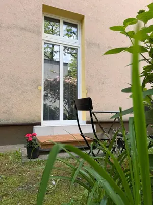 a black chair sitting in front of a window at Szlak Loft in Kraków