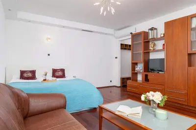 a living room with a bed and a couch at Krupnicza Family Studio with AC Quiet Krakow Old Town by Noclegi Renters in Kraków