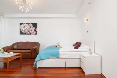 a white bedroom with a bed and a couch at Krupnicza Family Studio with AC Quiet Krakow Old Town by Noclegi Renters in Kraków