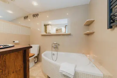 a kitchen with a sink and a yellow wall at New World apartment 54m, Kazimierz old town of Cracow in Kraków