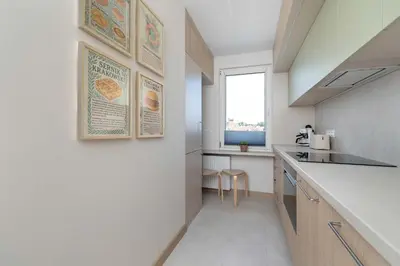 a kitchen with a counter and a window at Family Apartment with Air Conditioning with 3 Bedrooms in Cracow by Noclegi Renters in Kraków