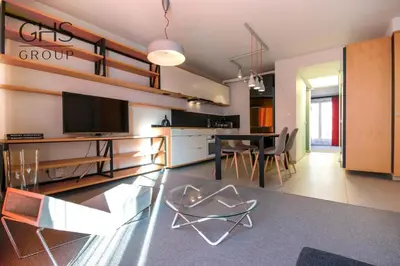 a living room with a table and a dining room at Ekskluzywny apartament, Browar Lubicz, FREE Parking in Kraków