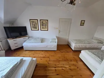 a room with two beds and a television in it at Pod Różą in Rząska