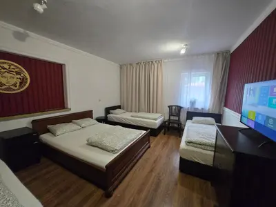 a bedroom with two beds and a flat screen tv at Pod Różą in Rząska