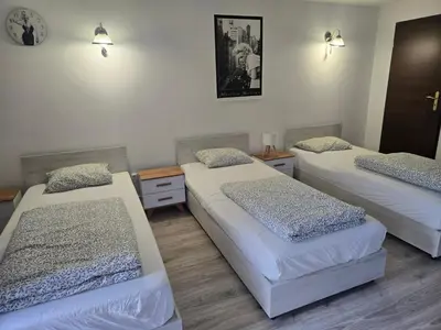 a room with three beds in a room at Pod Różą in Rząska
