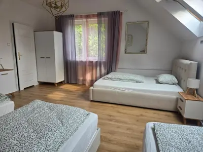 a bedroom with two beds and a window at Pod Różą in Rząska
