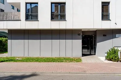 a building with its doors open on a street at Riverside Comfort Apartment by BookingHost in Kraków