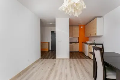 a kitchen with a dining table and a chandelier at Riverside Comfort Apartment by BookingHost in Kraków