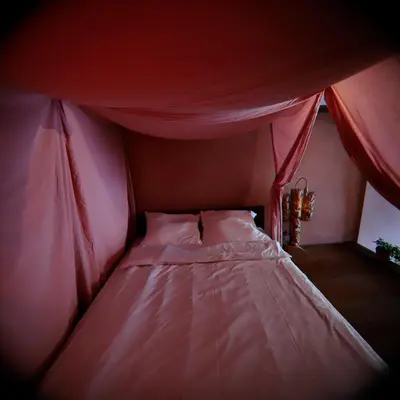 a bed in a red tent in a room at Rose & Thyme Artisan Studio in Old Town in Kraków