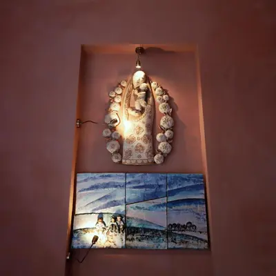 a chandelier hanging on a wall next to a painting at Rose & Thyme Artisan Studio in Old Town in Kraków