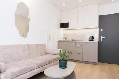 a living room with a couch and a table at Cozy Flat with a Garden in Kraków