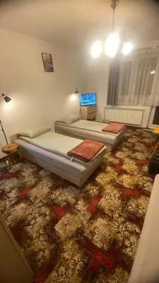 a bedroom with a bed and a sliding glass door at Pokoje Pod Lasem
