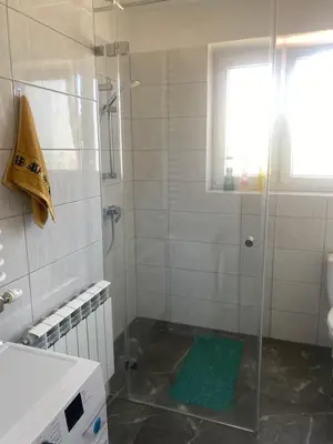 a shower with a glass door in a bathroom at Pokoje Pod Lasem