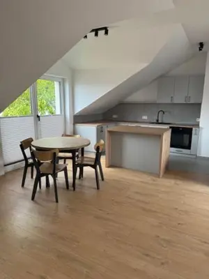 a kitchen with a table and chairs in a room at Apartament ,nocleg, wysoki standard in Niepołomice