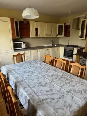 a kitchen with a table with chairs and a counter top at Bochnia ,nocleg, pokoje, kwatery pracownicze,dom in Bochnia